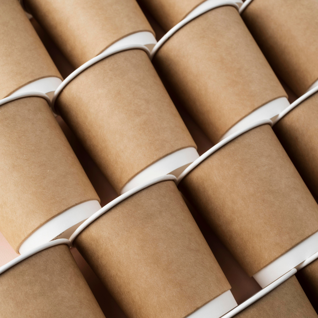 Various kraft paper products including envelopes, cups, and utensils