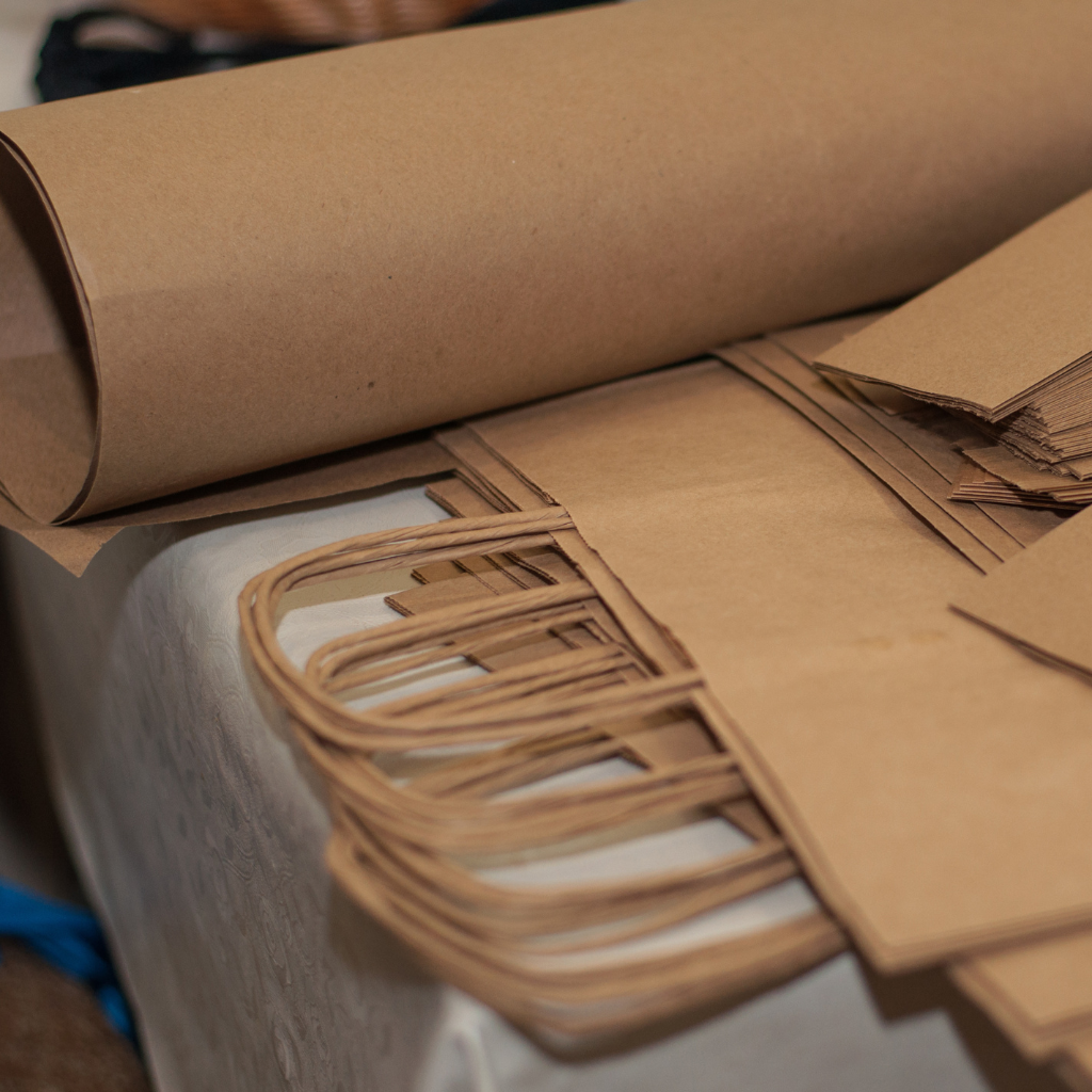 Various kraft paper products including envelopes, cups, and utensils